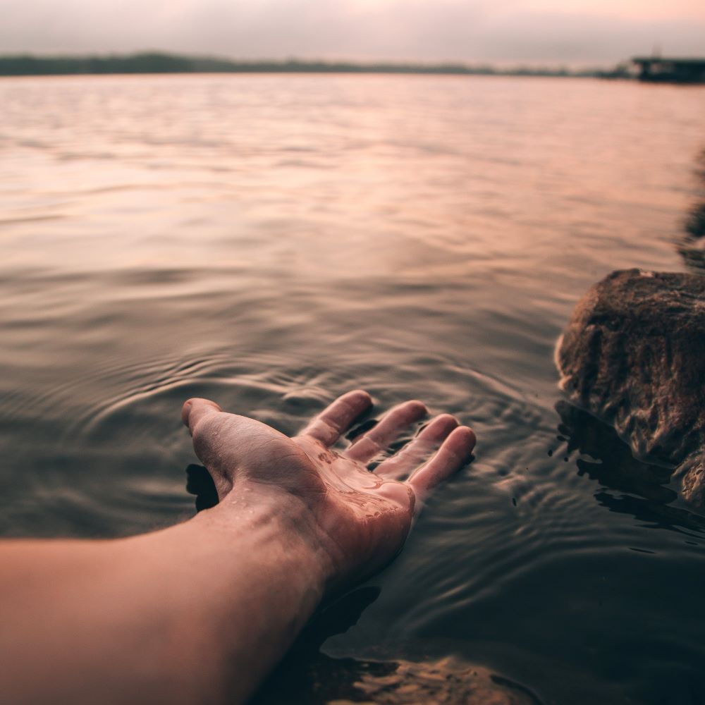 Hand resting in water